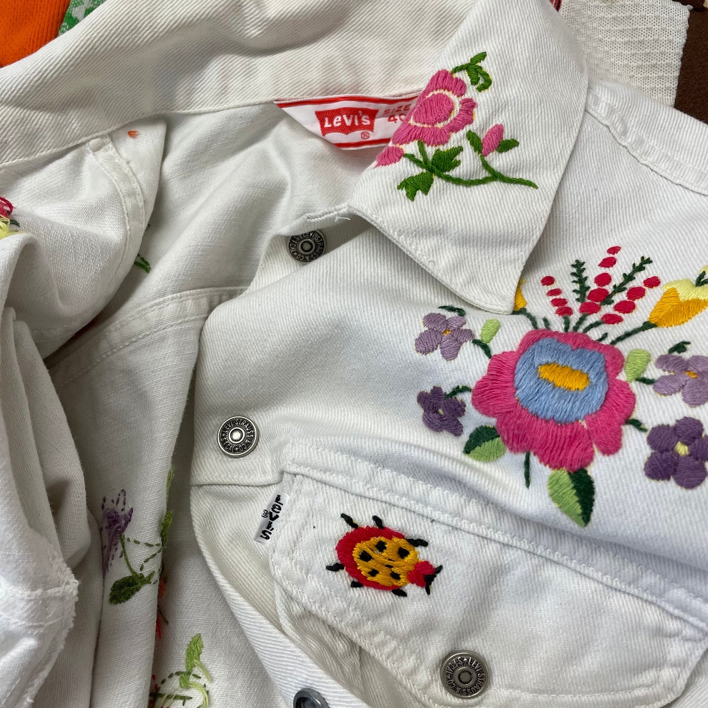 vtg levi's FLORAL EMBROIDERED white jean jacket ꕤ ꕤ flowers and bugs nudie suit sweetheart rodeo country rock western ranch wear parsons