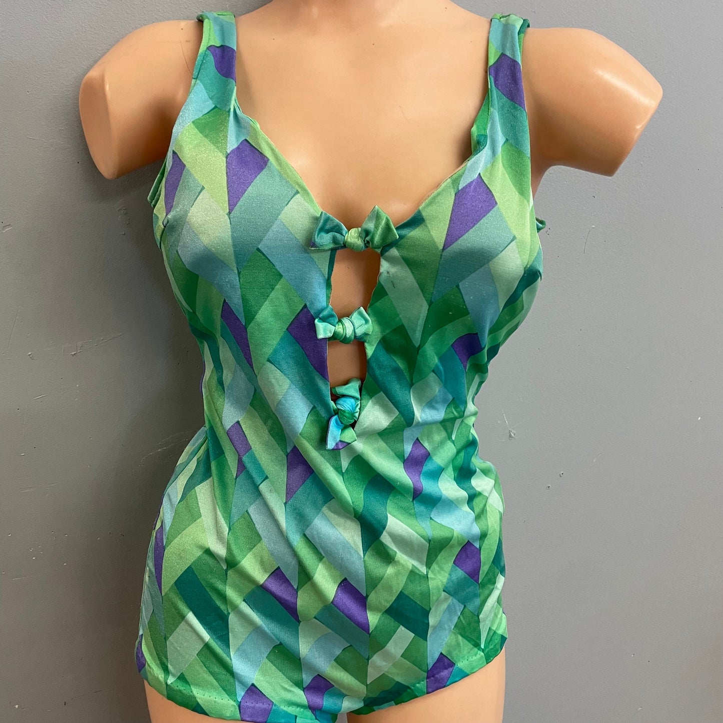 Vintage 70s psychedelic geometric print cut out swimsuit mod retro low cut boy short one piece bathing suit bright green blue bow ties