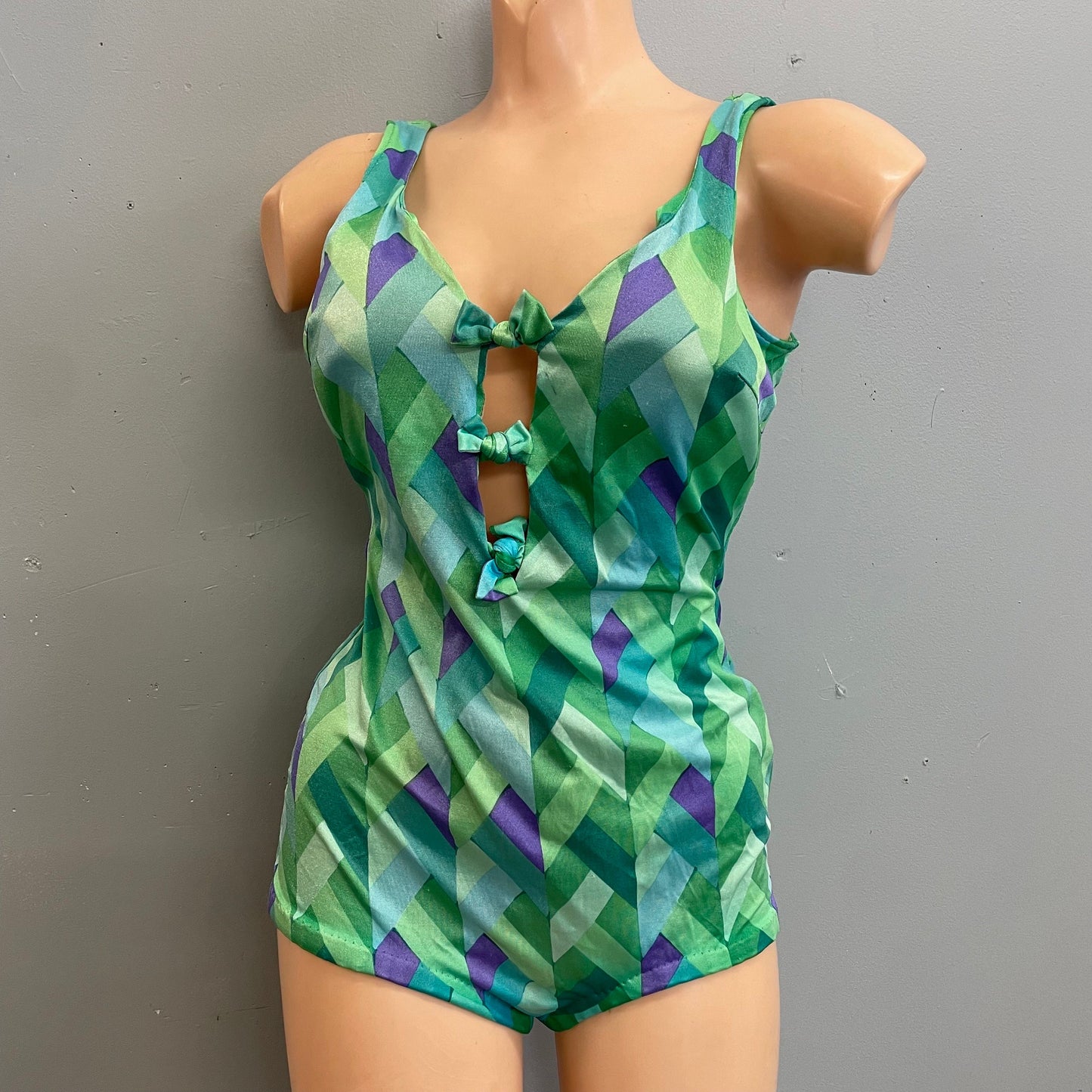 Vintage 70s psychedelic geometric print cut out swimsuit mod retro low cut boy short one piece bathing suit bright green blue bow ties